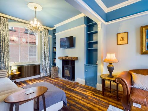 a living room with a couch and a fireplace at Ogleforth in York