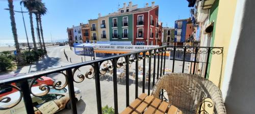 a balcony with a chair and a view of a street at AR28-1, Coqueto apartamento en primera línea de playa in Villajoyosa