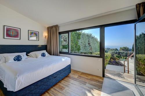 a bedroom with a bed and a large window at The View Aix-en-Provence in Aix-en-Provence