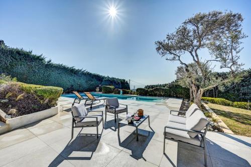 a patio with chairs and a table next to a swimming pool at The View Aix-en-Provence in Aix-en-Provence