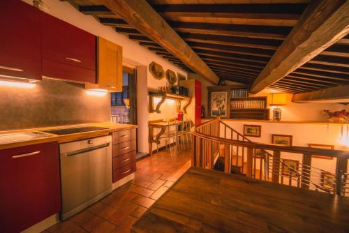 a kitchen with a staircase leading to a dining room at Book and Bed in Orvieto