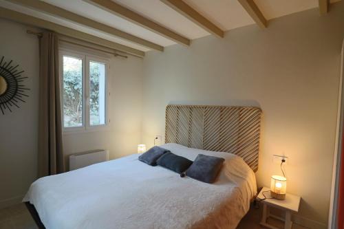 a bedroom with a bed with two pillows on it at Le mas Sainte Marie in Venasque