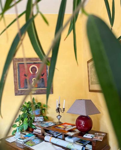 a table with a lamp and books on it at Maison Sainte Barbe in Autun