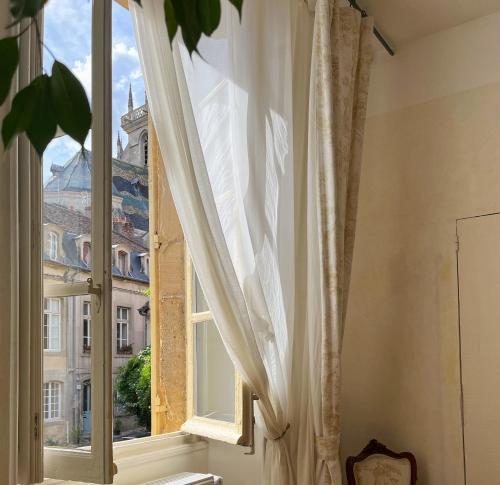 a window with a view of a building at Maison Sainte Barbe in Autun