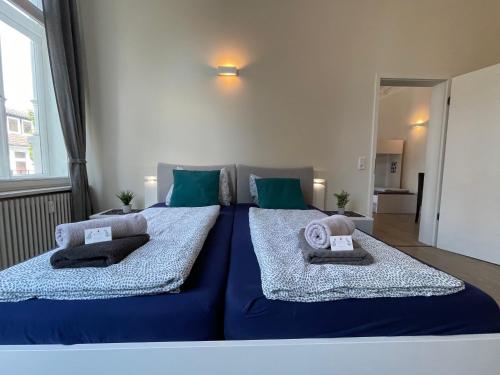 a large bed with two pillows on top of it at Gäste-Liesel Bad Pyrmont in Bad Pyrmont