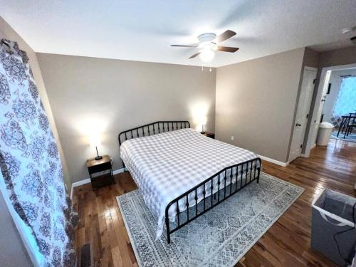 a bedroom with a bed and a ceiling fan at Peaceful Townhouse Near Lake in Guntersville
