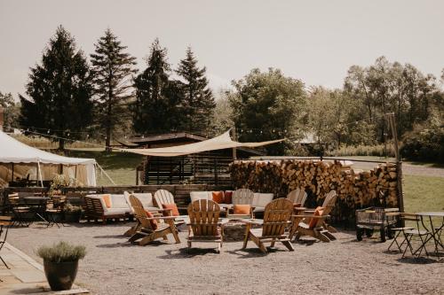 a group of chairs and tables and a tent at Firelight Camps in Ithaca