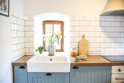 a kitchen counter with a sink and a window at Kristian - House and Garden in Český Krumlov