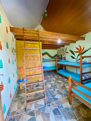 a room with two bunk beds and a ladder at Greensoul Hospedagem in Ubatuba