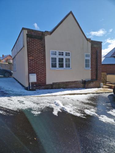 a house with snow on the ground in front of it at The Lodge, 9 Dene House in Gateshead