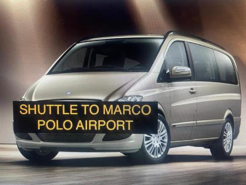 a silver minivan with a sign that says shuttle to marco polo airport at Torre Antica Venice Airport Hotel in Tessera