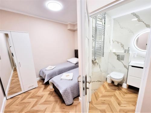 Cette petite chambre comprend 2 lits et des toilettes. dans l'établissement Orange Tree Hotel, à Będzin
