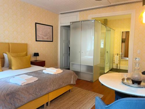 a bedroom with a bed and a glass shower at The Brewmaster's House in Porto