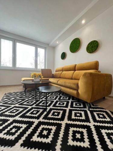 a living room with a couch and a rug at Komfort byt s parking zadarmo in Košice