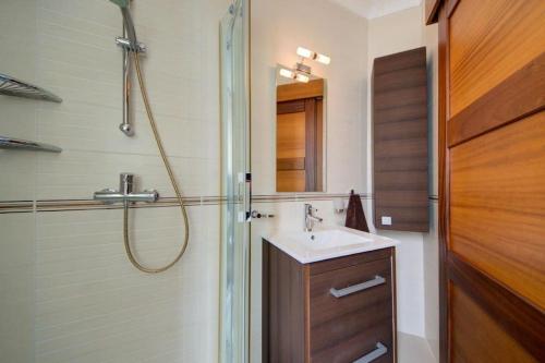 a bathroom with a shower and a white sink at Amazing 1 bedroom with views in Mellieha in Mellieħa