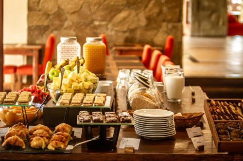 a table with various pastries and other food on it at Sent Calafate in El Calafate