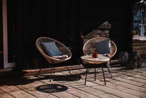 two chairs and a table with a cup on a porch at Schloss Gamlitz in Gamlitz