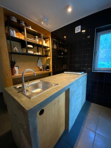 a kitchen with a sink and a counter top at Kemény Klára Parti Háza in Zamárdi