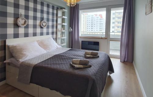 a bedroom with a bed with two towels on it at Holiday Home SLAVIA NEW 408 z widokiem na morze in Międzyzdroje