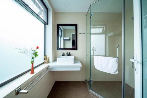 a bathroom with a sink and a glass shower at My Anh Boutique Villa Hoi An in Hoi An