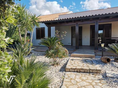 a house with a garden and a patio at Villa Tico in Custonaci