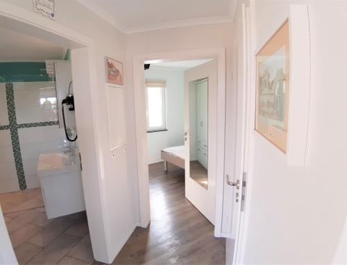 a bathroom with a sink and a toilet in a room at Strandbungalow Jette in Glowe