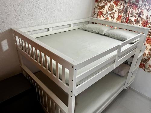 a white bunk bed in a room at Meu Loft Geribá em Búzios in Búzios