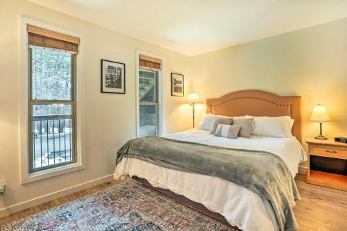 a bedroom with a large bed and two windows at Seventh Mountain Condo with Resort Amenities! in Bend