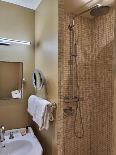 a bathroom with a shower and a sink at Hotel Vendome - BW Signature Collection in Vendôme