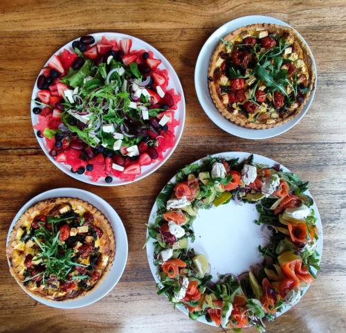 four plates of food on a wooden table at The Vineyard on Ballito in Ballito