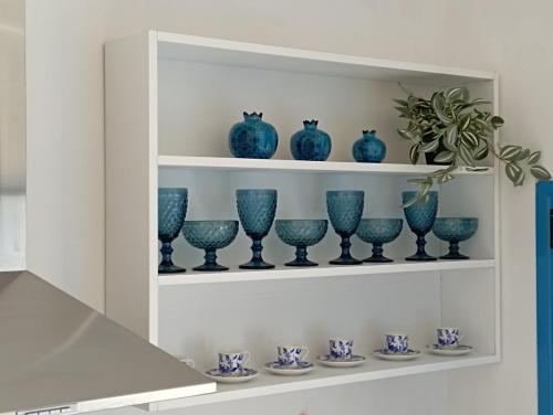 a shelf with blue glass vases on it at Olympos Princess in Olympos