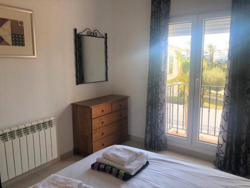 a bedroom with a bed and a dresser and a window at Casa Ricardo - A Murcia Holiday Rentals Property in Roldán