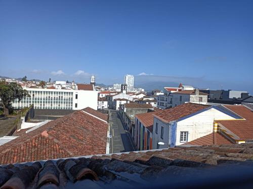 a view of a city with roofs and buildings at Santo Cristo Apartments in Ponta Delgada