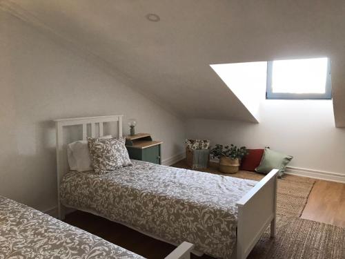 a bedroom with a bed and a window at Santo Cristo Apartments in Ponta Delgada