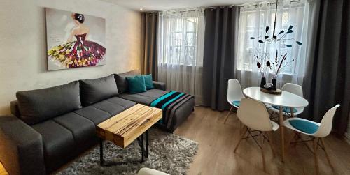 a living room with a couch and a table at Die Altstadt Appartements Caprice in Goslar