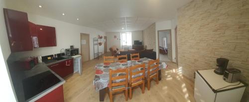 a kitchen and dining room with a table and chairs at Cramiland - Super appart 5 pers centre ville in Montbéliard