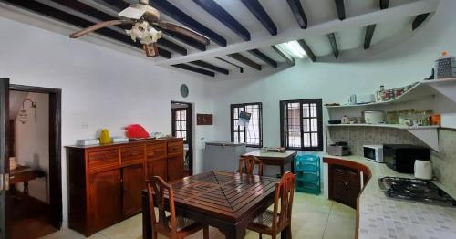a kitchen with a wooden table in a room at Kenyan House Malindi in Malindi