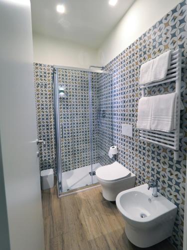 a bathroom with a shower and a toilet and a sink at Le Nicchie - Ospitalità di Puglia in Bisceglie