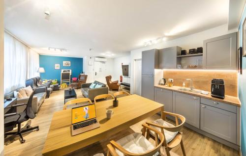 a kitchen and a living room with a table and chairs at Jimmy's Apartments Lory in Vienna
