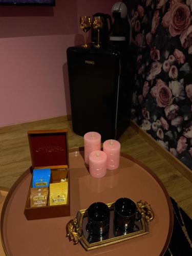 a table with a tray of candles and a mirror at Les suites d'Élise - Suite Élise in Grumesnil