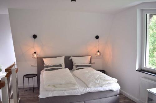 En eller flere senge i et værelse på Schönes Apartment (Nr. 9) über 2 Etagen
