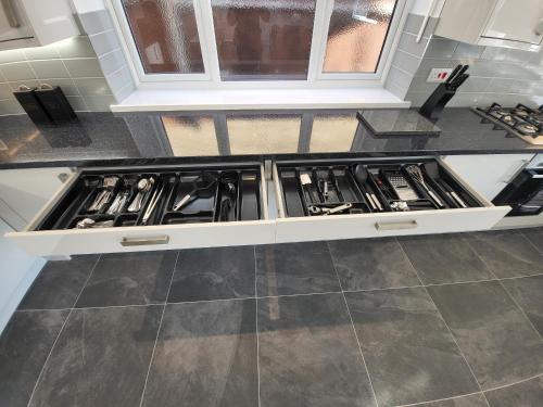 a kitchen with a stove top oven in a kitchen at High Spec Large 6 Bedroom House! in Kingston upon Thames