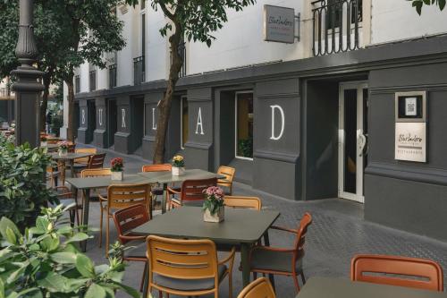 a row of tables and chairs outside of a restaurant at Hotel Colón Gran Meliá - The Leading Hotels of the World in Seville