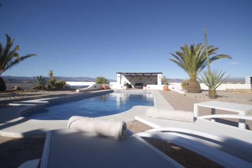 a swimming pool in front of a house at Villa Alta Vista in Albox