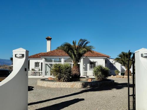 a white house with palm trees in front of it at Villa Alta Vista in Albox