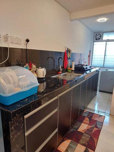 a kitchen with a sink and a counter top at Islamic Homestay Apartment Kundang, Rawang in Rawang