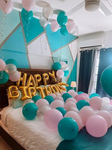 a room with a bunch of balloons and a bed at Aqua Marina Beach Club in Rincon