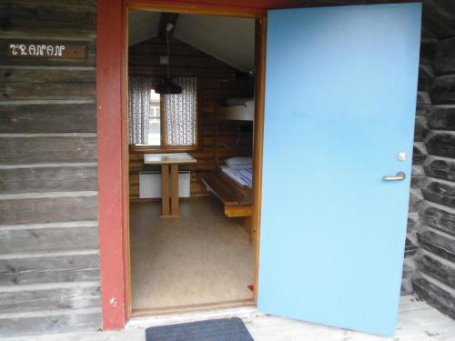 a door leading into a room with a bed at First Camp Enåbadet - Rättvik in Rättvik