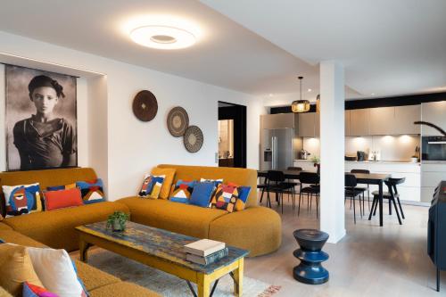 a living room with two couches and a dining room at Les 7 Anges - Cathédrale de Reims in Reims