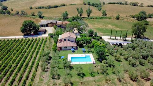an aerial view of a house with a pool in a field at Il Girasole Terzuolo in Manciano